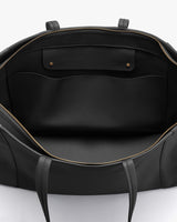 Open handbag viewed from the top showing interior pockets