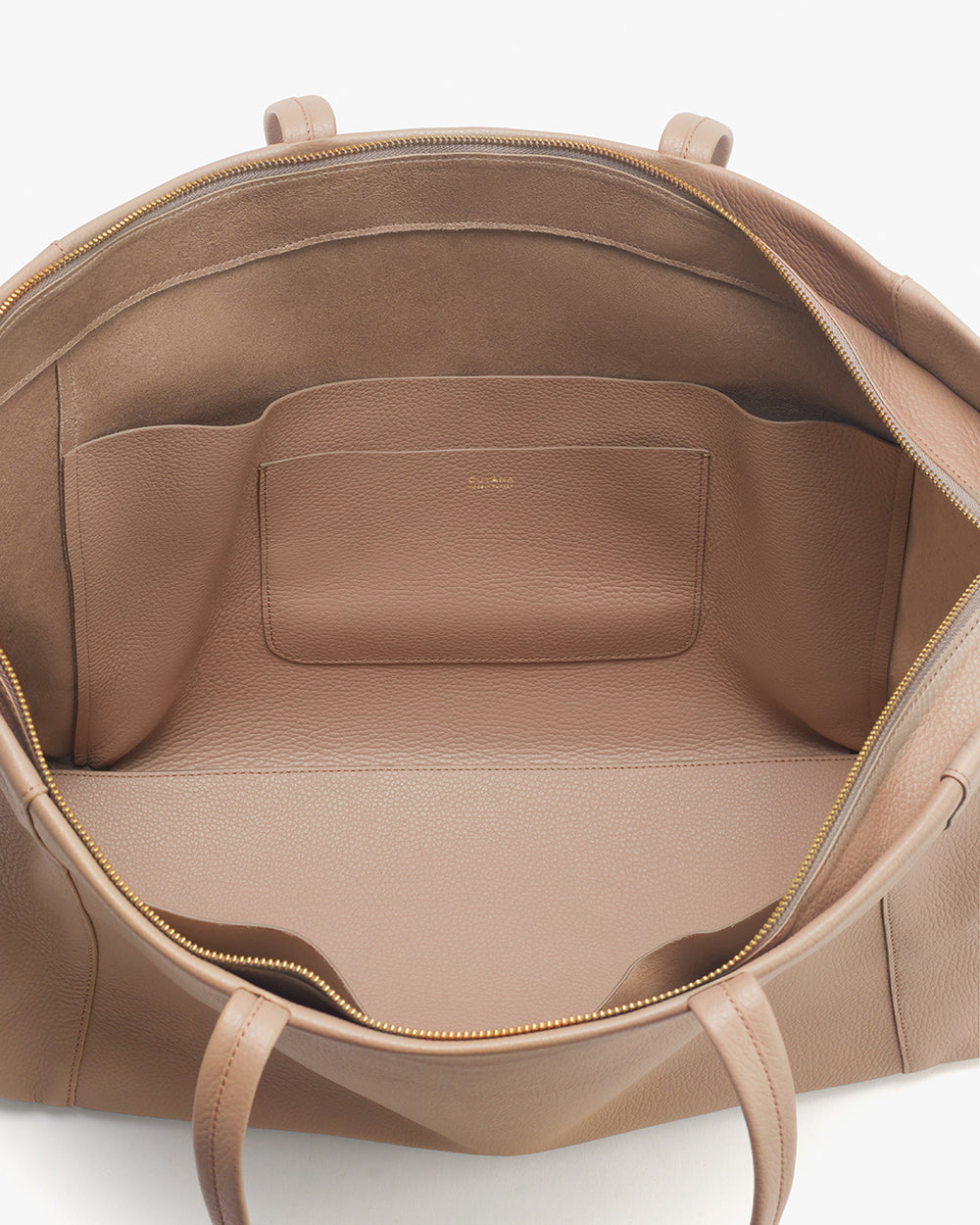 Open handbag showing interior with pockets.