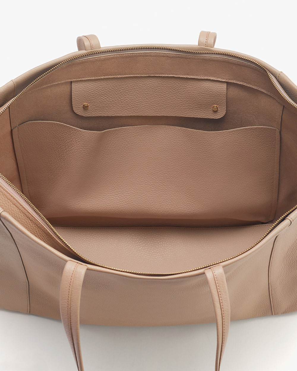 Easy Overnighter Bag Open handbag showing interior pockets and design details.