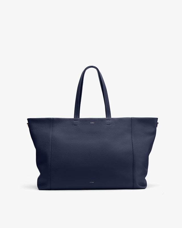 Large tote bag with handles and a flat bottom, standing upright.