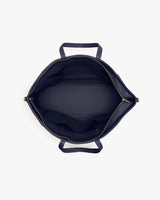 Top view of an open travel bag showing internal compartments and handles.