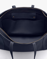 Open handbag viewed from the top showing inner compartments.
