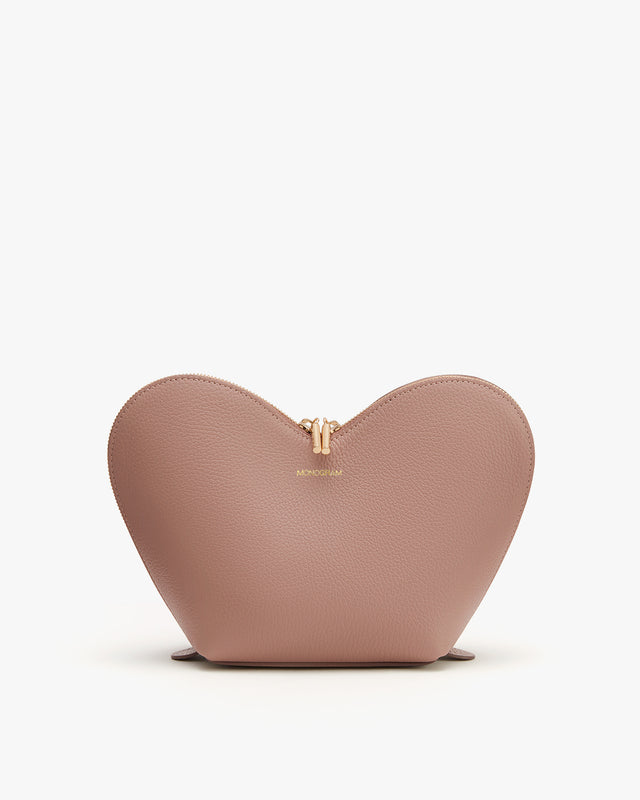 Heart-shaped purse with a brand logo on the front.