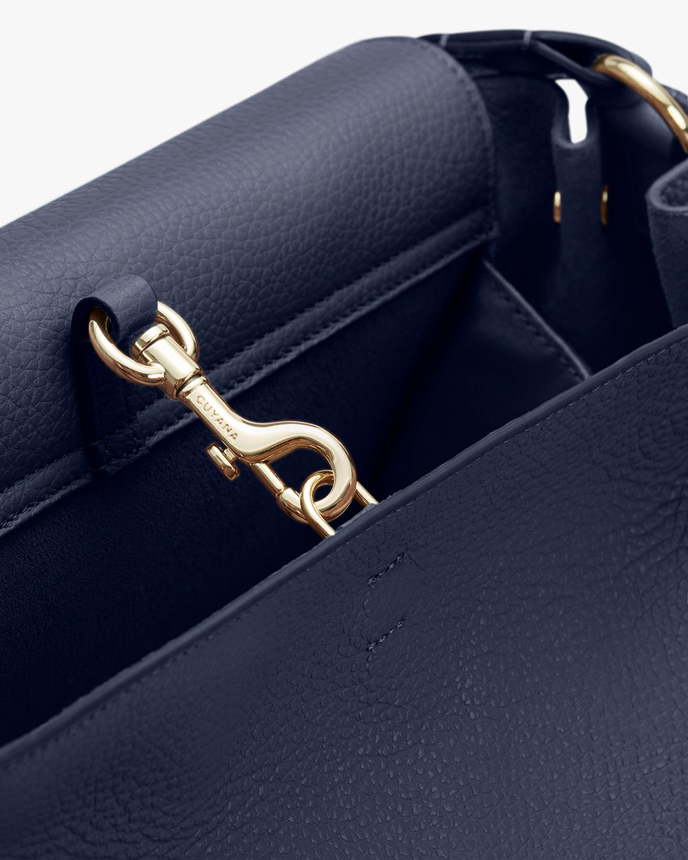 Close-up of a handbag with a metal clasp.