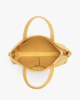 Open handbag viewed from the top showing the interior.