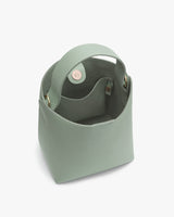 Open handbag with a circular handle viewed from the top.