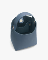 Open-top handbag with rounded handles and a visible interior.