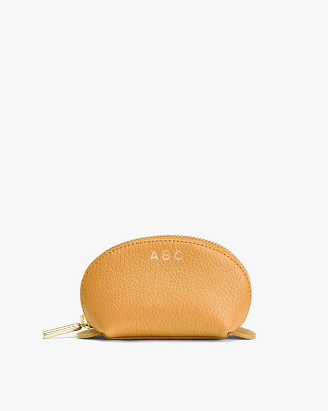 Small zippered pouch with initials ABC on front.