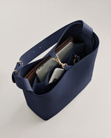 Open tote bag with compartments containing personal items.