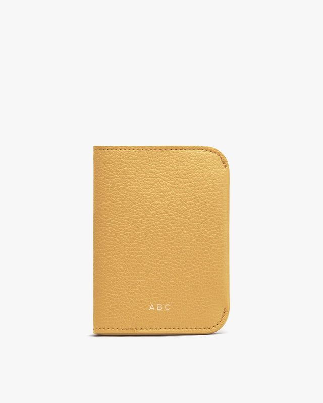 Personalized wallet with initials 'ABC' on a plain background.