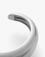 Close-up of a curved metallic object with engraved text.