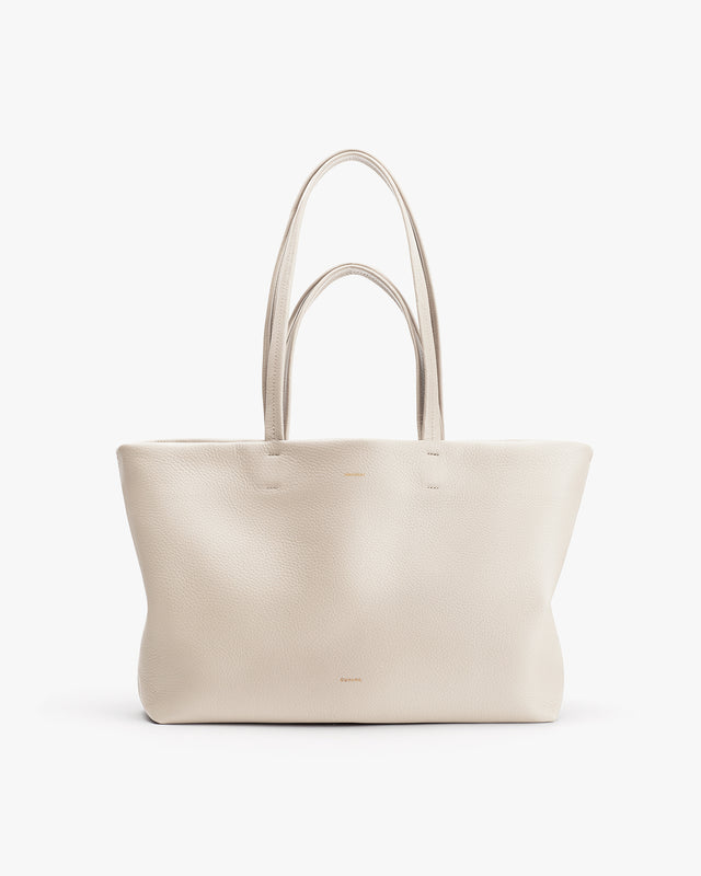Plain tote bag with two handles standing upright.