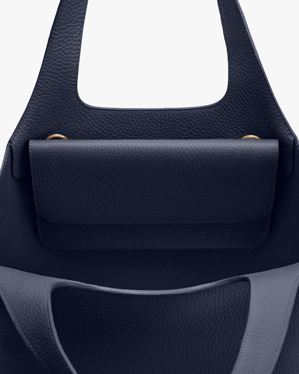 System Flap Bag Close-up view of a handbag with a flap closure and handle.