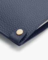 Close-up of a wallet with a snap button closure.