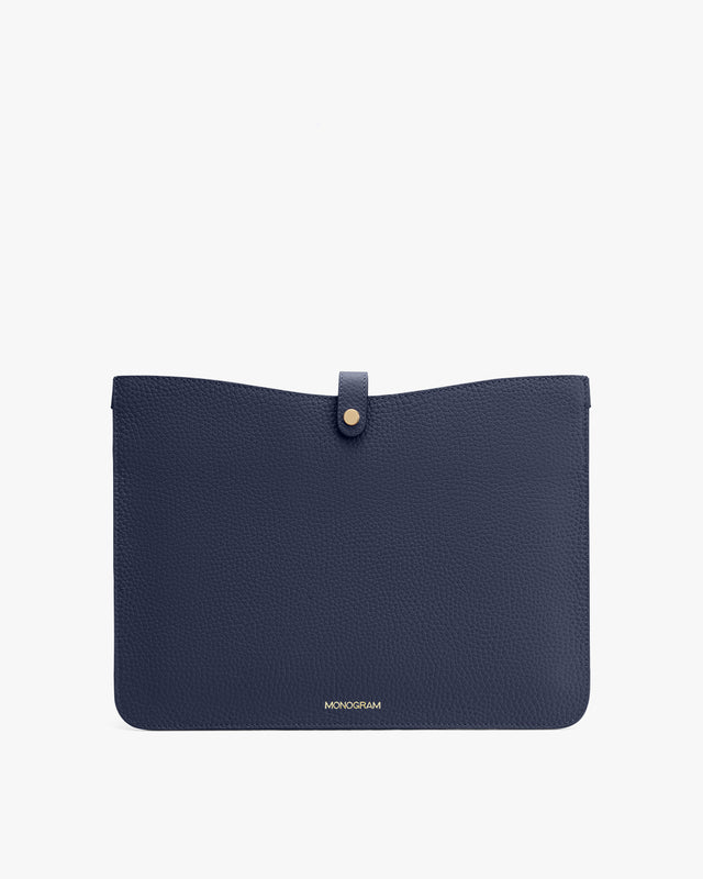 Flat pouch with a front flap and button closure.