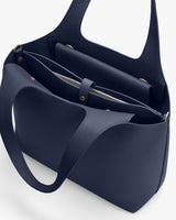 Open handbag with two handles and an inner zipper pocket.