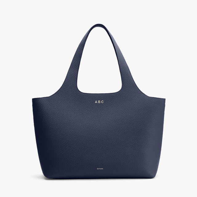 Monogrammed tote bag on a plain background