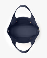 Top view of an open empty handbag with handles.