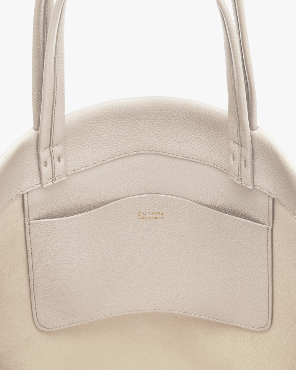 Small Easy Tote Close-up of a handbag with brand logo on the front pocket.