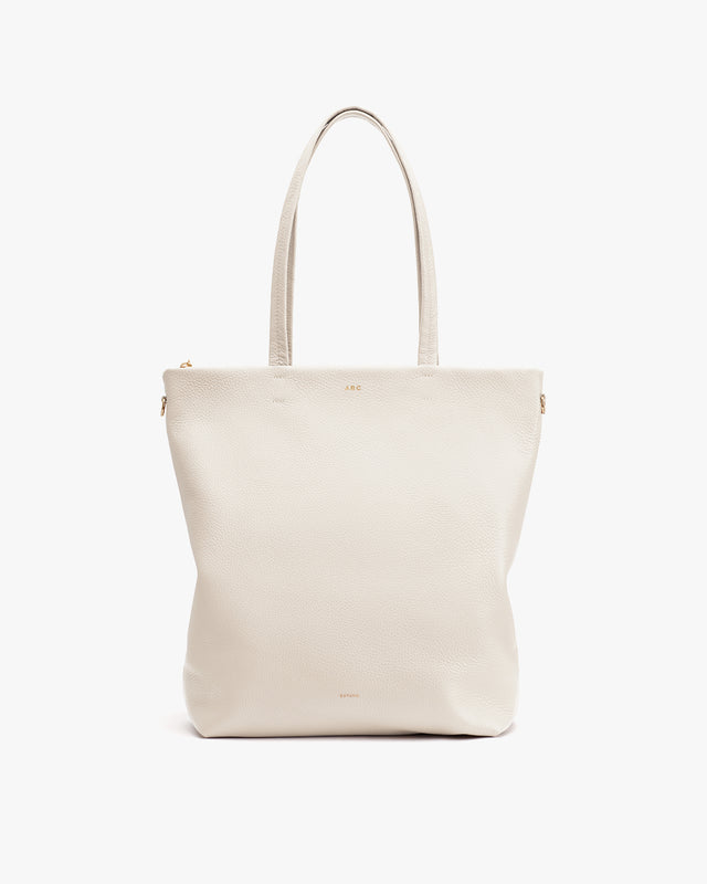Vertical tote bag with two handles and a minimalist design.