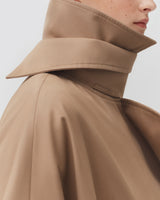 Close-up of a person wearing a high-collared jacket.