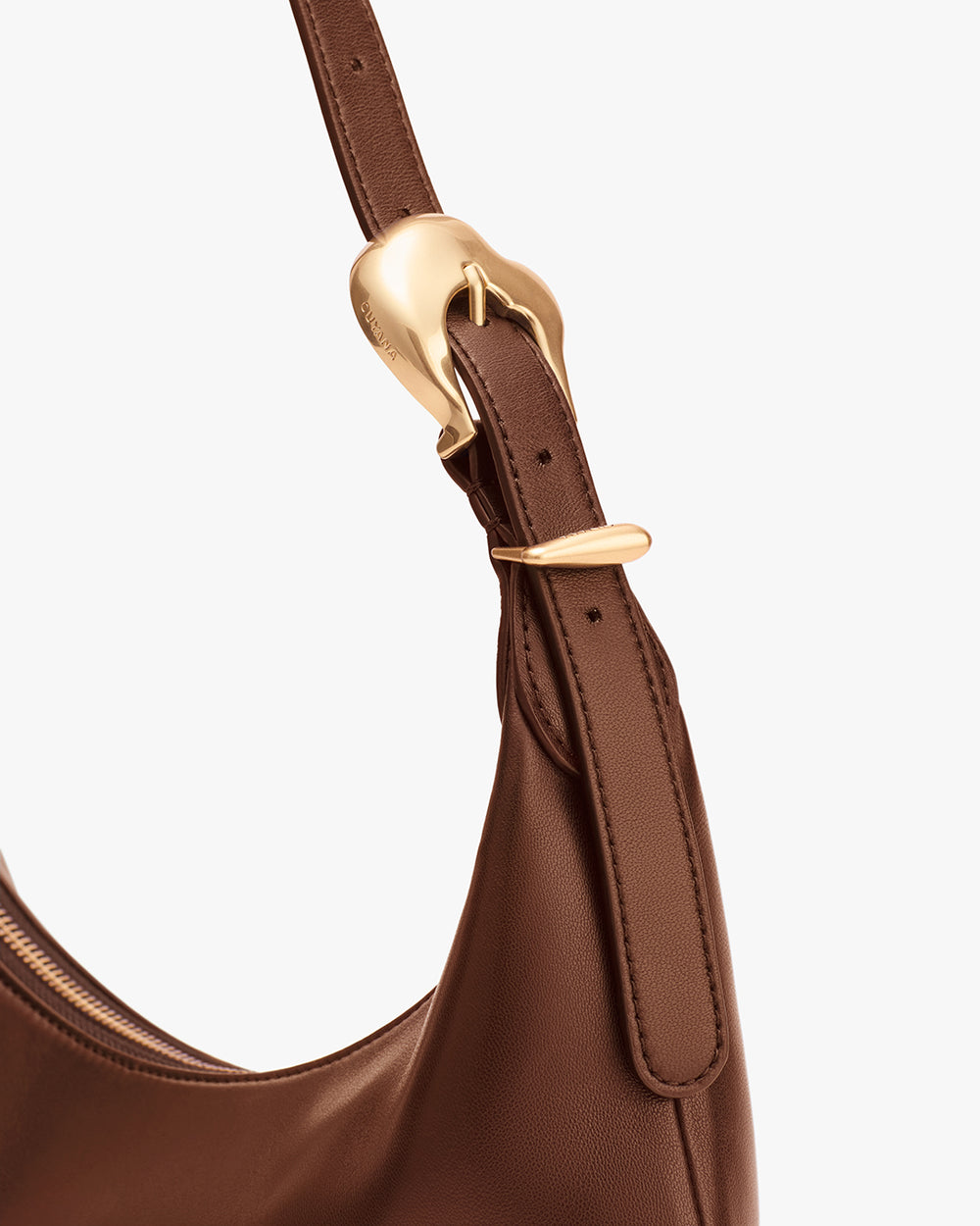 Close-up of a bag strap with a metal buckle detail