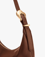 Close-up of a bag strap with a metal buckle detail