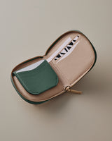 Open zippered wallet with card slots and folded card.