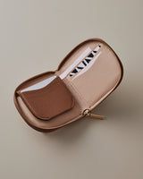 Wallet with a zippered pocket open, showing a card inside.