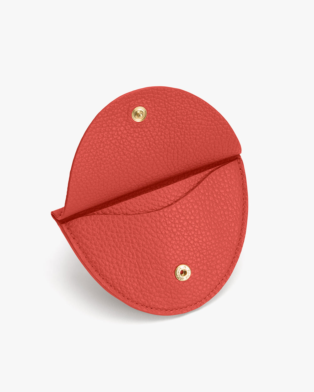 Round leather wallet with snap button closure.