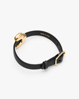 Round bracelet with gold accents and buckle clasp