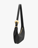 Shoulder bag with a curved shape and gold zipper.