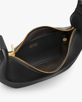Open handbag with visible interior pocket and zipper.