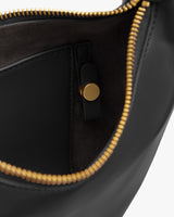 Open bag with gold zipper and small interior pocket.
