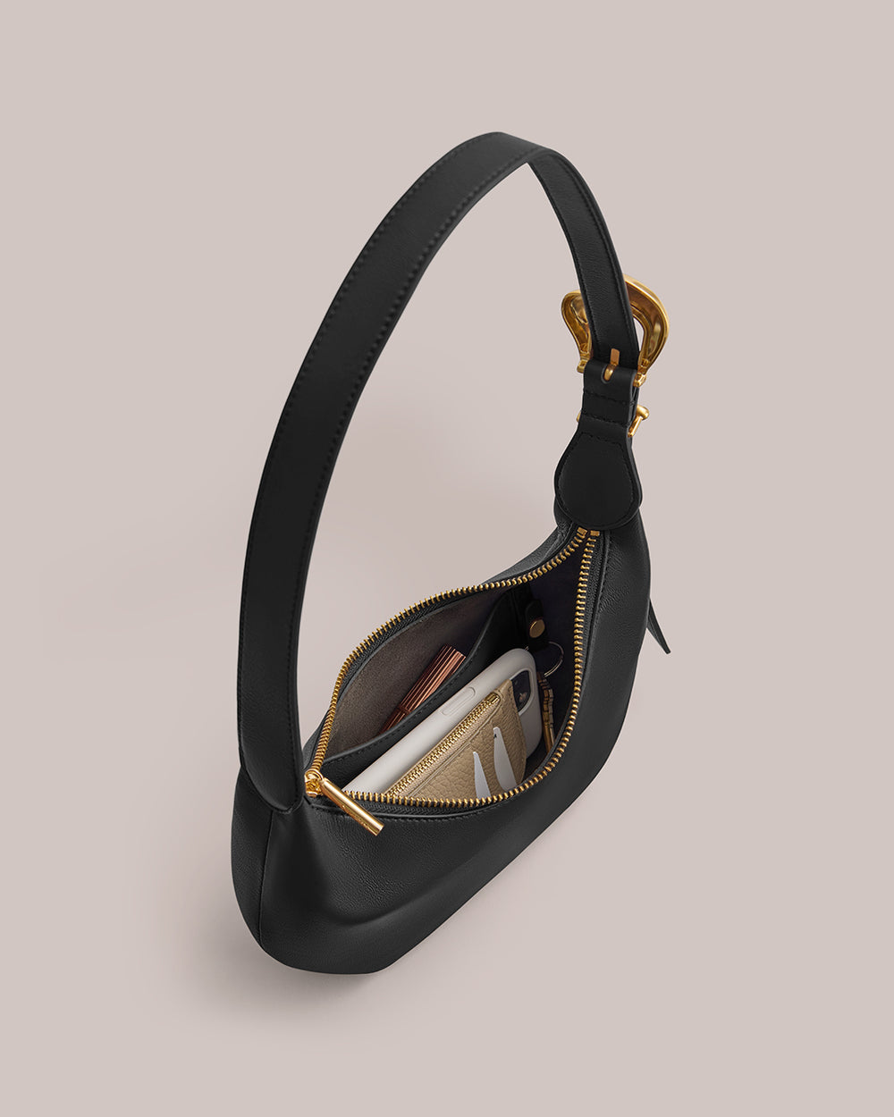 Handbag with an open zipper revealing contents inside.