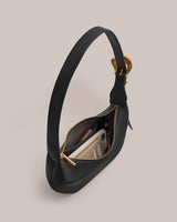 Handbag with an open zipper revealing contents inside.