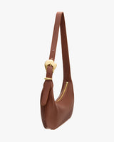 Shoulder bag with a zipper and curved strap.