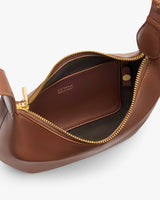 Open handbag with visible interior pocket and zipper.