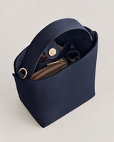 Handbag with gold accents and a zipper pocket inside