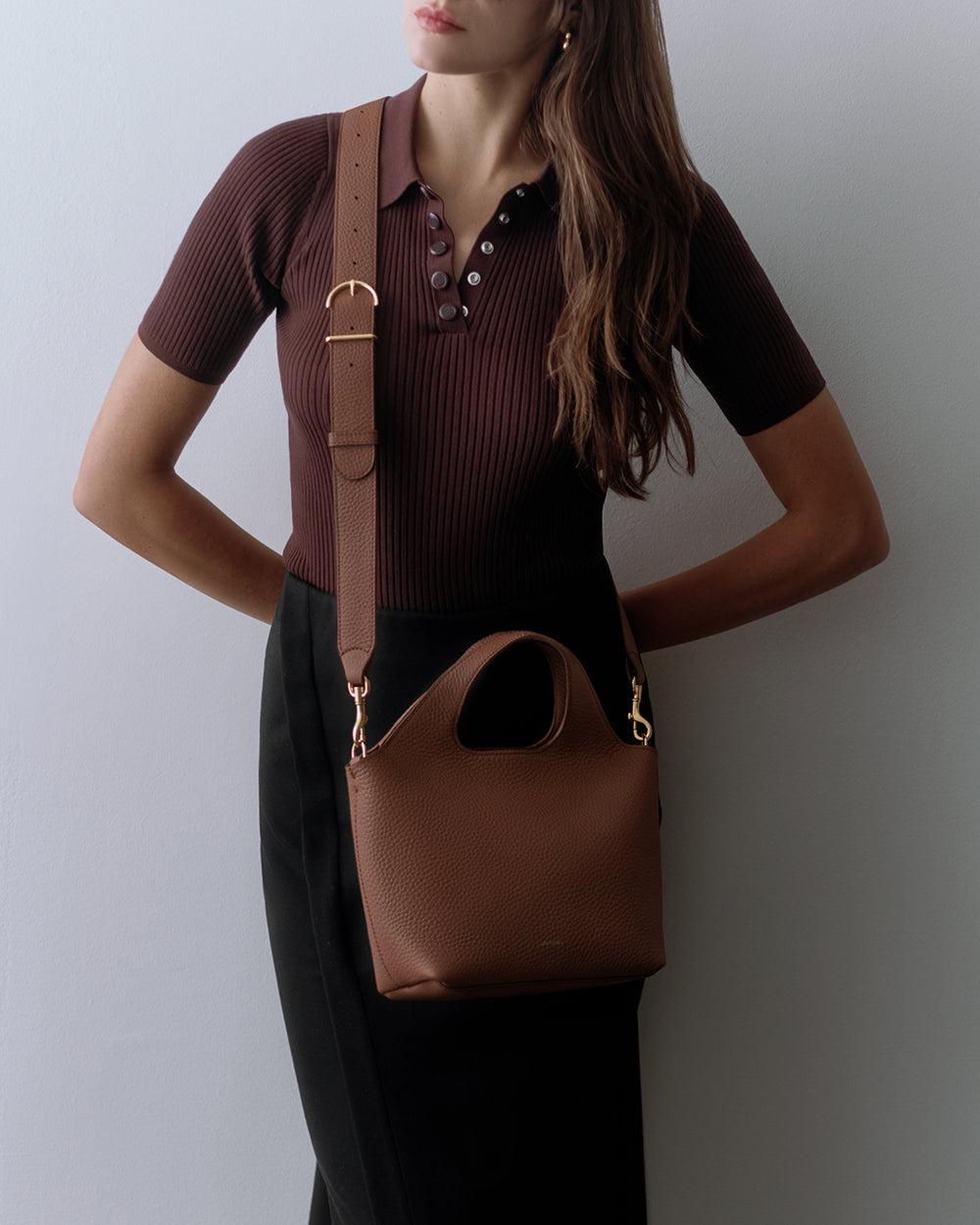Mini System Tote Person wearing a short-sleeve shirt and skirt with a shoulder bag