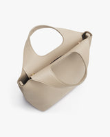 Minimalist handbag with large handle opening and a structured design.