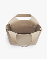 Open handbag with a wide handle and a spacious interior pocket.