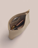 Open zipper pouch with cosmetic items inside.