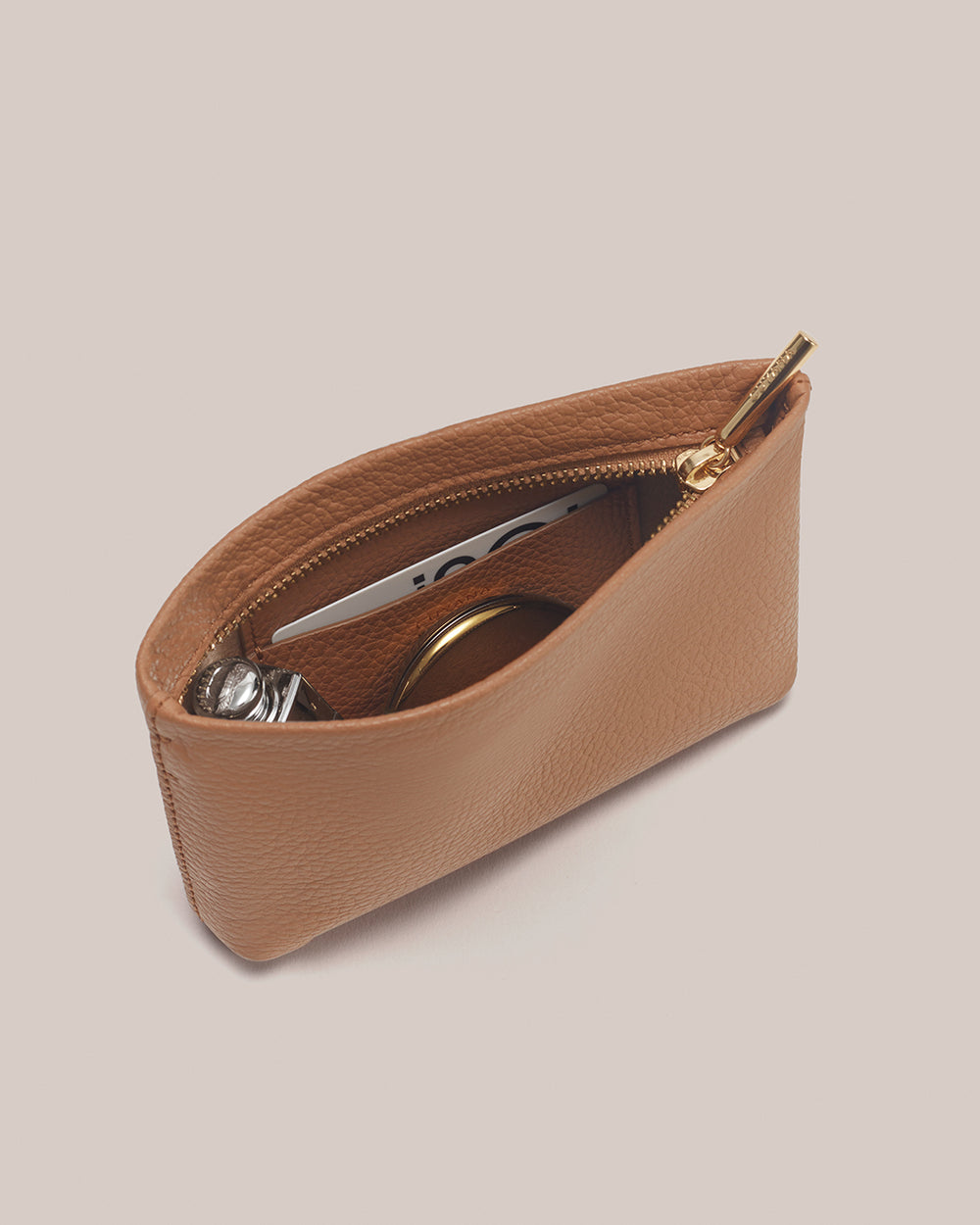 Nano Zipper Pouch Open pouch with zipper, containing a card, perfume and a compact mirror.