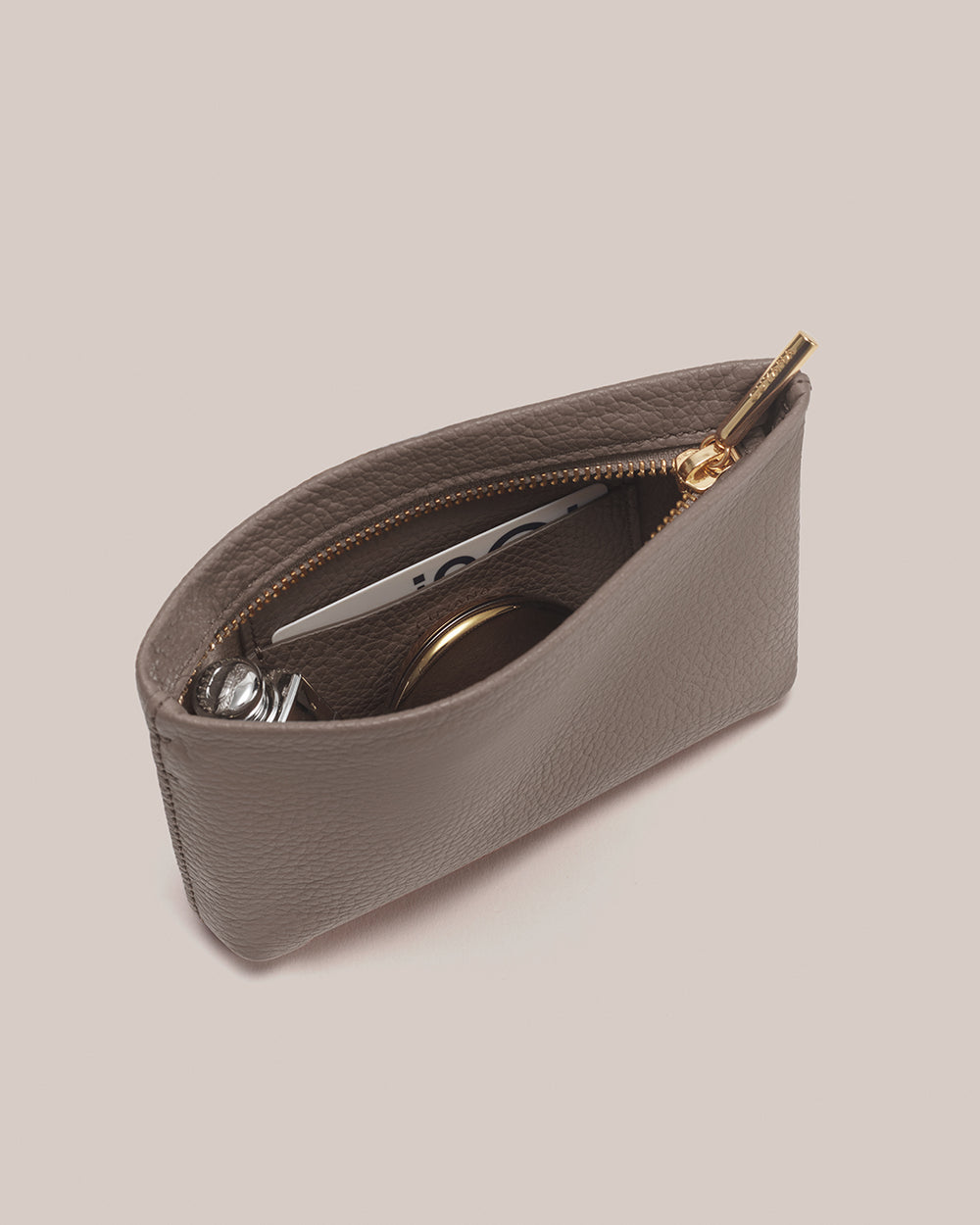 Nano Zipper Pouch Open pouch with zipper, containing a card, perfume and a compact mirror.