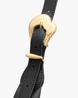 Close-up of a belt buckle with a curved metal clasp.