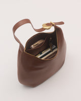 Open handbag with contents including a wallet and keys visible