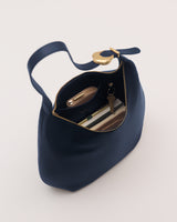 A handbag with an open zipper, showing contents like a wallet and keys.
