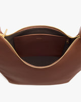 Open handbag with visible interior pocket and zipper.