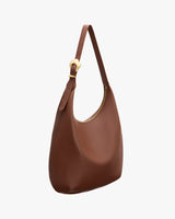 Shoulder bag with a curved shape and adjustable strap